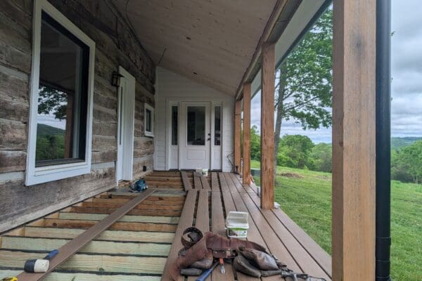 Composite decking installation on a covered porch by a deck builder in Middle Tennessee.