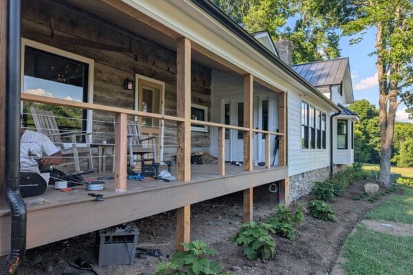 Covered outdoor living space with composite decking and cable railings by an outdoor living contractor in Middle Tennessee.
